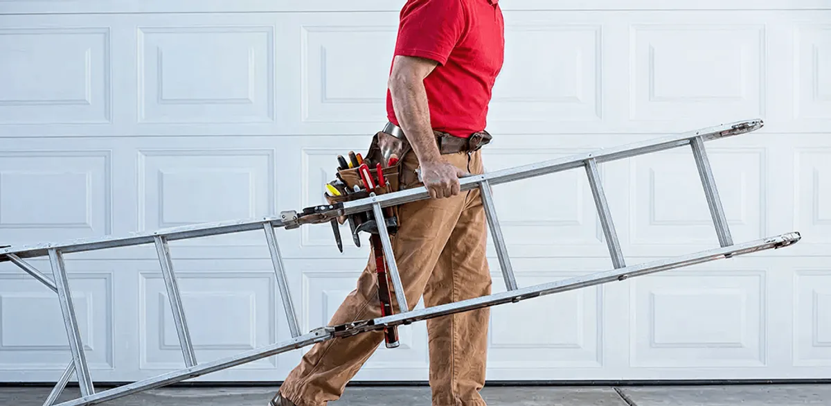 Garage door repair technician arriving with tools and ladder in Cincinnati, OH
