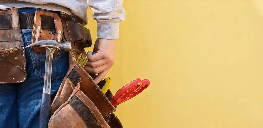 Handyman with tool belt ready for home repairs and maintenance in Cincinnati, OH