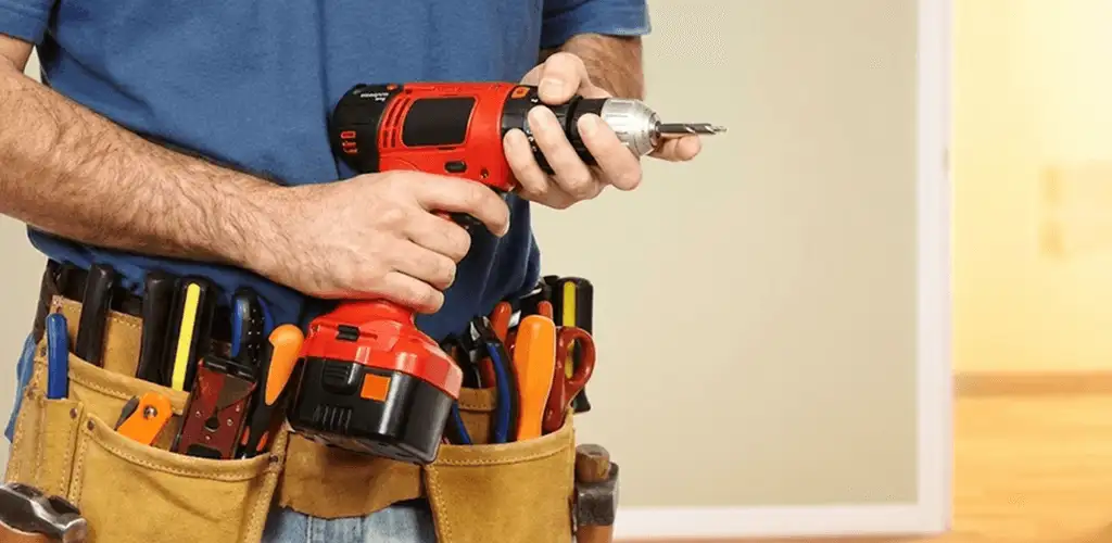 Handyman holding a power drill for home repairs and installations in Cincinnati, OH