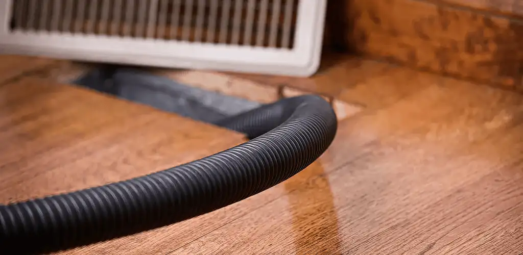 Air duct cleaning hose inserted into a floor vent for ductwork cleaning in Cincinnati, OH