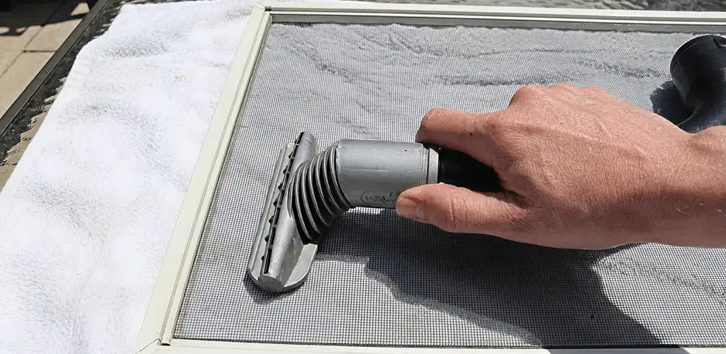 Window screen repair cleaning and fixing a damaged screen mesh in Cincinnati, OH